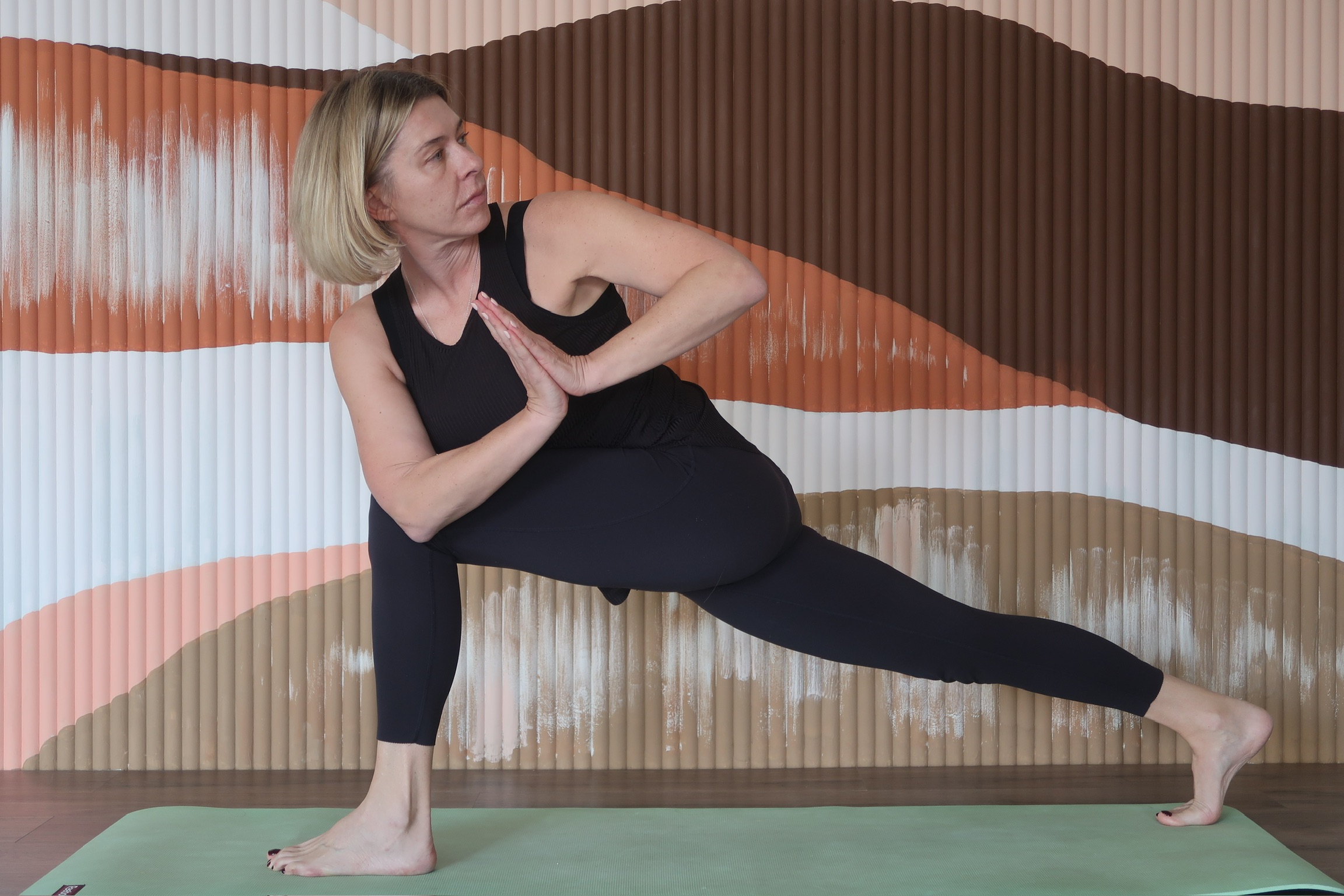 a woman front of a colourful wall